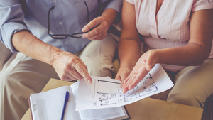 man and woman looking at house plans