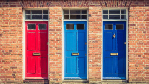 Three front doors, each with different colours.