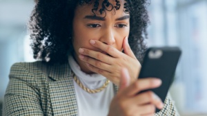 businesswoman shocked at something on her phone