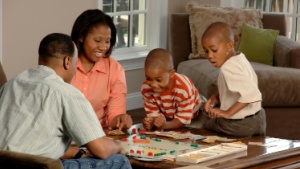 a family playing the board game Monopoly